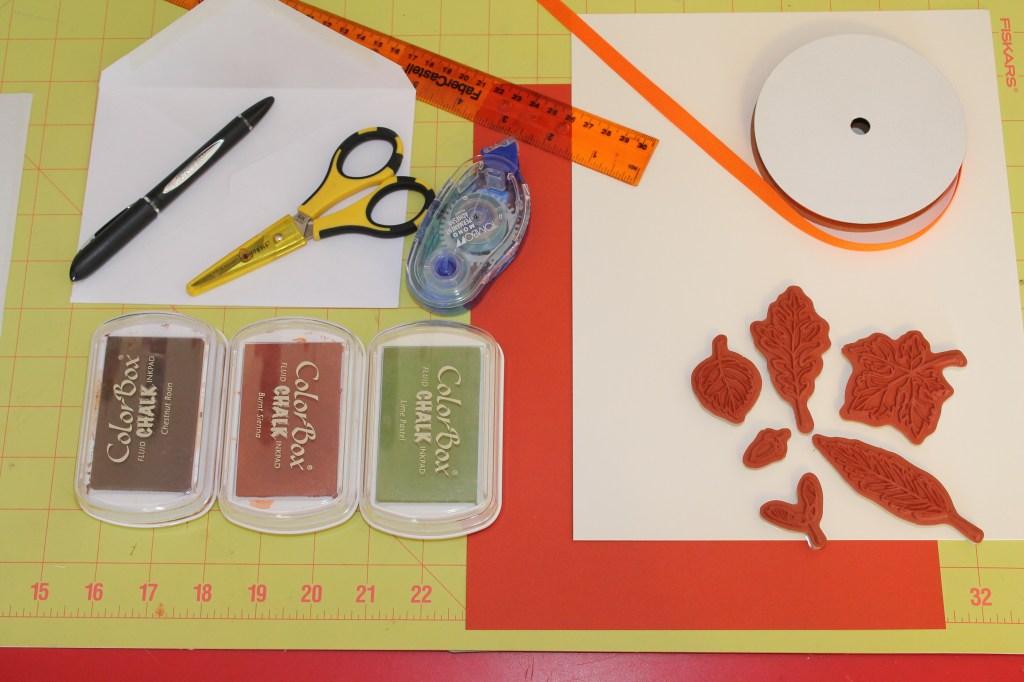 Supplies needed:  Ink, Cardstock, Ribbon, Ruler, Scissors, Adhesive, Pen, Envelope, Rubber Stamps