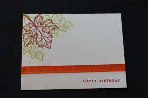 Stamp 3 leaves and sentiment, adhere ribbon to fron of card and wrap excess around the back of the card.